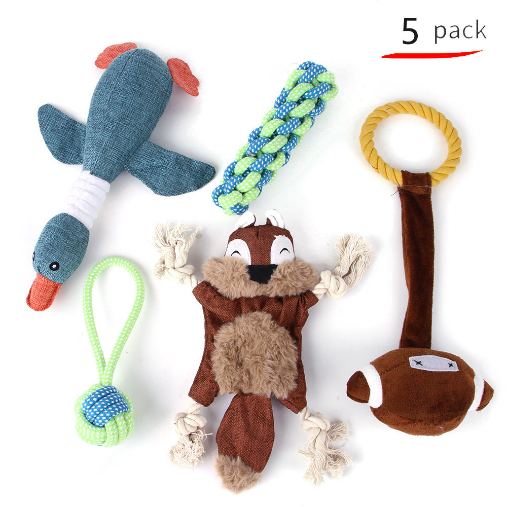 Five dog toys including a blue fish, green rope, and brown animal-shaped toys on a white background.